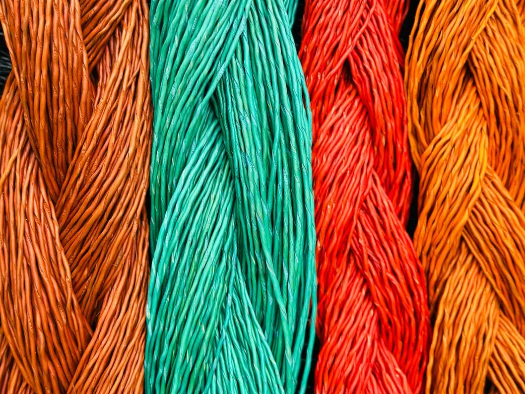 Close view of orange, green and red dyed straw