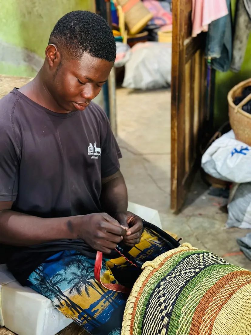 A member of the leather team fitting leather to a basket handle